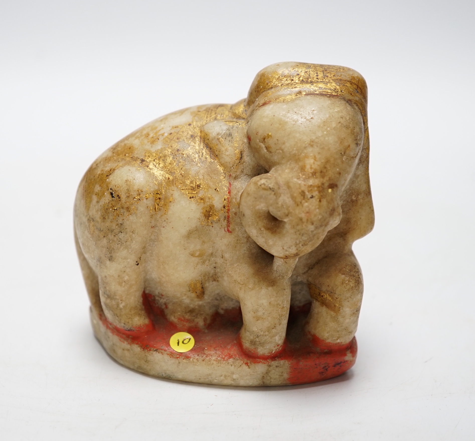 An Indian carved and painted alabaster model of an elephant, 10cm tall